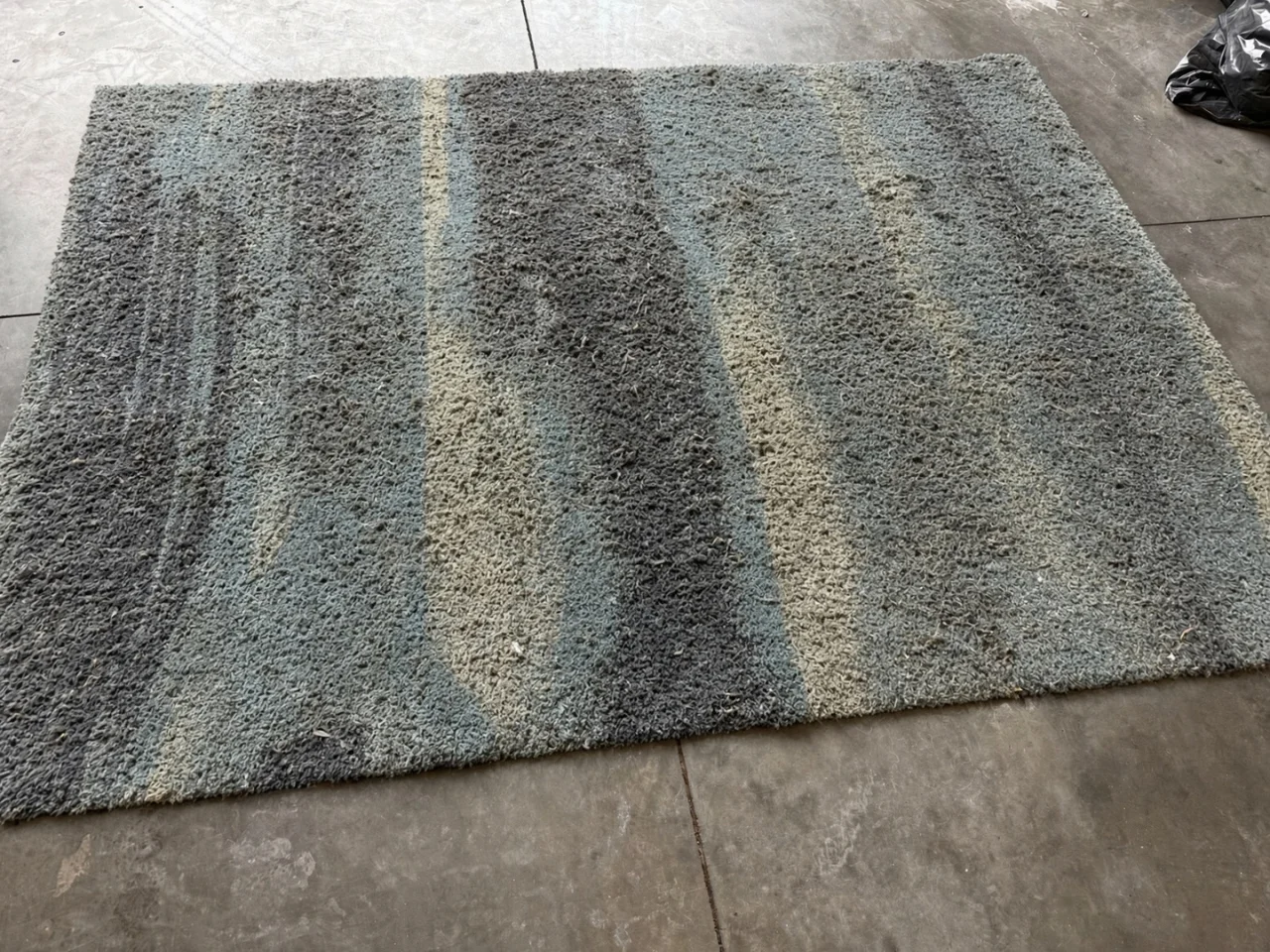 Before: faded, heavily soiled ocean-blue shag rug from a Camas, WA home before cleaning