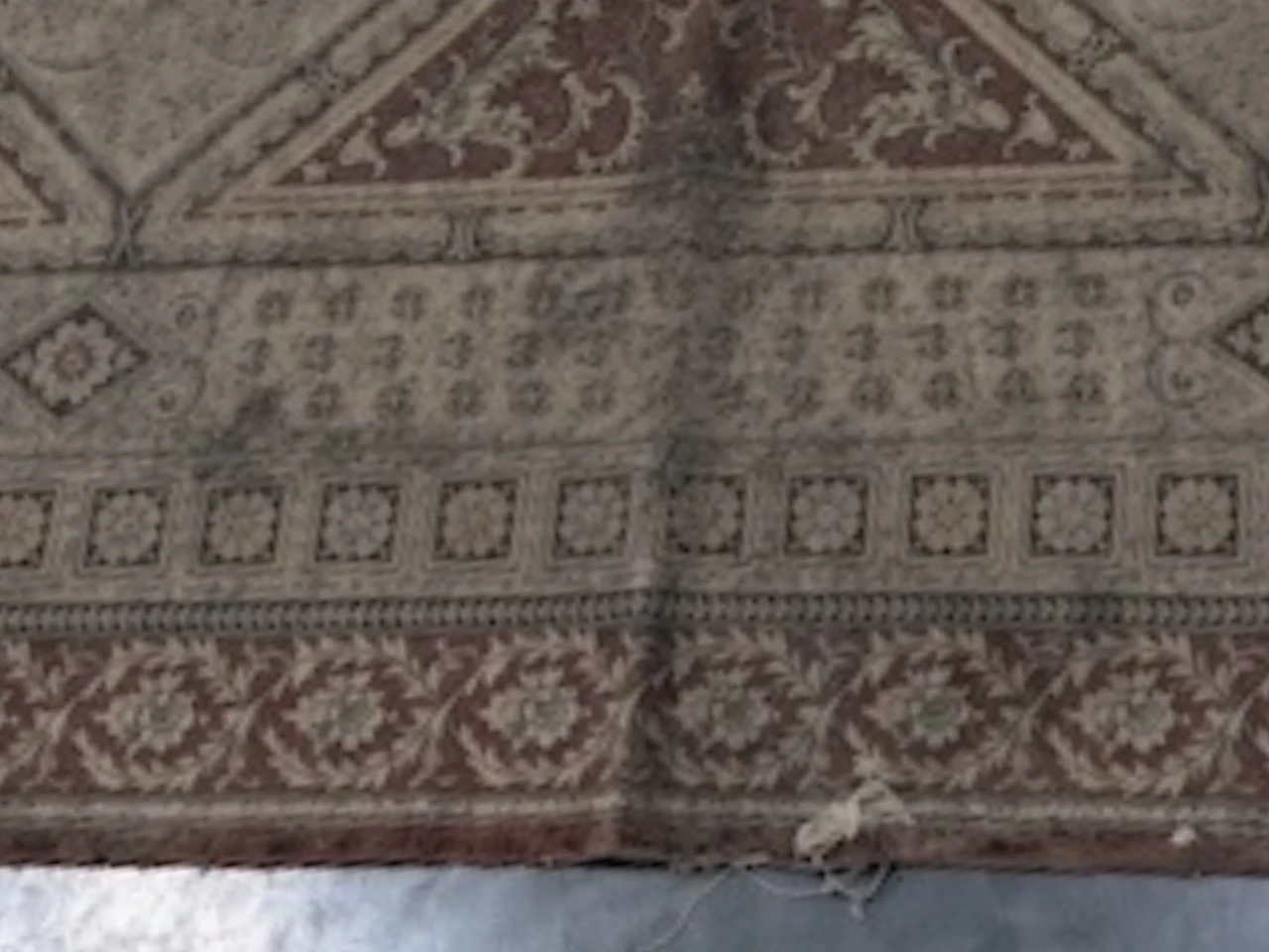 Close-up of heavy soiling on the heirloom silk rug