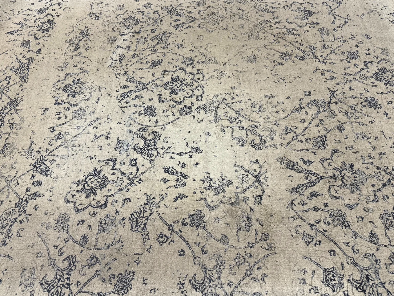 Before: heirloom 8x10 white-and-blue silk rug from a Ridgefield, WA home before cleaning