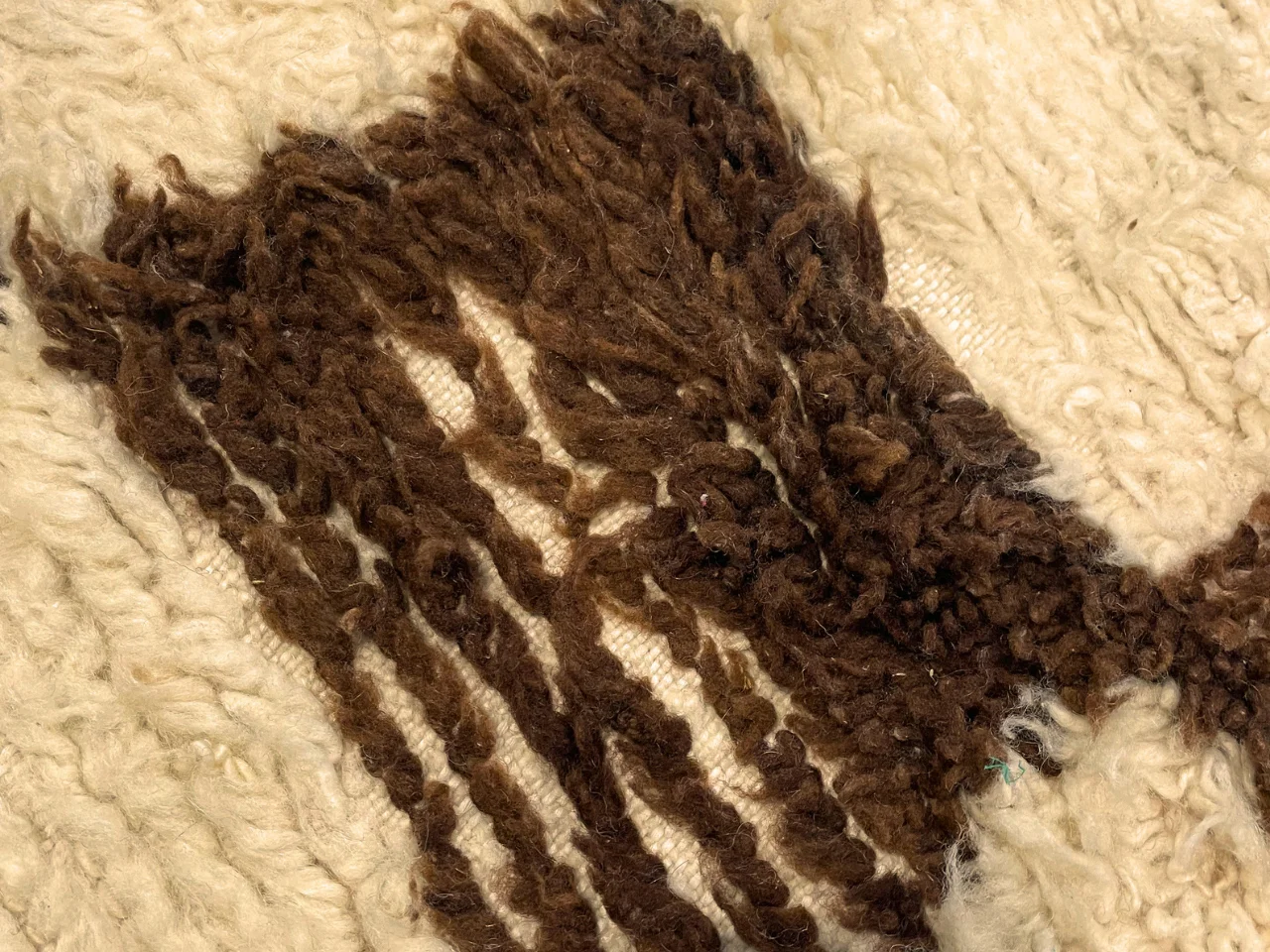 A second inspection photo of the sheep’s wool rug at the Benchmark plant