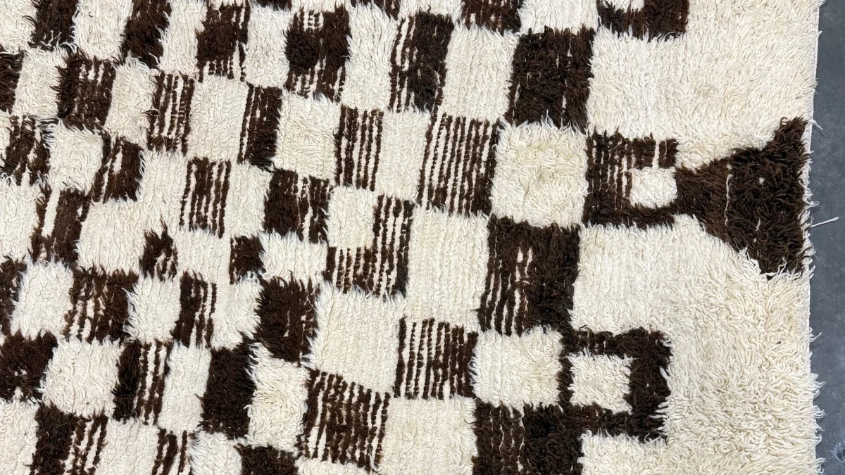 The cleaned sheep’s wool checkerboard rug presented in the West Linn home