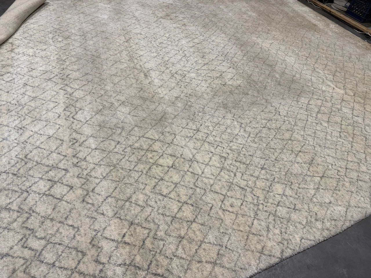 The modern 9x12 wool rug on arrival at the Benchmark plant before washing